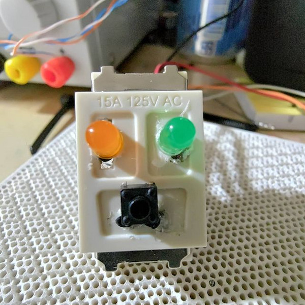 electrical outlet converted into an LED and button holder