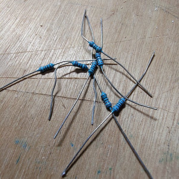 Various 1/4 watt resistors sitting on a wooden table